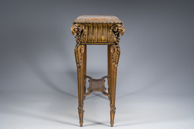 A French Louis XVI style gilt and carved woorden side table with ram's heads and a red marble top, 19th C.