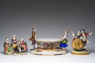 Two polychrome Saxon porcelain groups, a table piece and a cup and saucer, Germany, 19th/20th C.