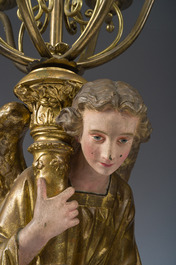 An impressive pair of polychrome decorated plaster angels mounted into ten-light candlesticks, 20th C.