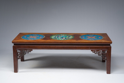 A Chinese rectangular wooden table inlaid with three round cloisonn&eacute; plaques with floral design, 20th C.