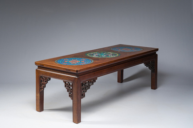 A Chinese rectangular wooden table inlaid with three round cloisonn&eacute; plaques with floral design, 20th C.