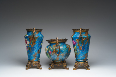 A French three-piece polychrome faience fine bronze mounted garniture with floral design, Creil Montereau Boulenger et Cie, 19th C.