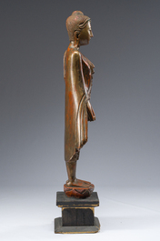 A tall Thai inlaid gilt lacquered wooden figure of a standing Buddha, 20th C.