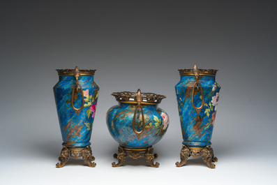 A French three-piece polychrome faience fine bronze mounted garniture with floral design, Creil Montereau Boulenger et Cie, 19th C.