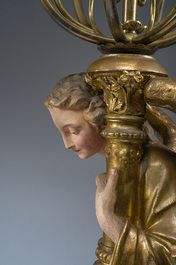 An impressive pair of polychrome decorated plaster angels mounted into ten-light candlesticks, 20th C.