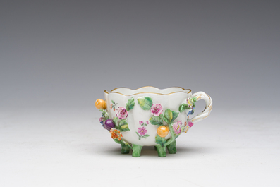 Two polychrome Saxon porcelain groups, a table piece and a cup and saucer, Germany, 19th/20th C.