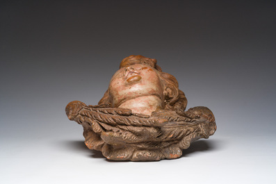 A polychromed terracotta cherub head, probably France, 18th/19th C.