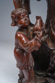 A large Chinese carved wooden figure of Guanyin with children, 20th C.