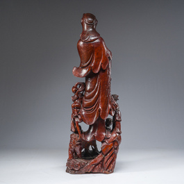 A large Chinese carved wooden figure of Guanyin with children, 20th C.