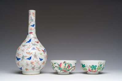 A Chinese famille rose '100 butterflies' vase and two bowls with peaches and balsam pears, Qianlong mark, 20th C.