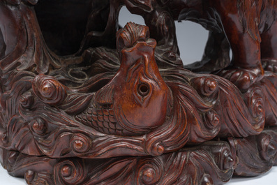 A large Chinese carved wooden figure of Guanyin with children, 20th C.