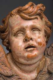 A polychromed terracotta cherub head, probably France, 18th/19th C.