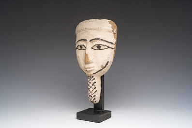 An Egyptian wooden sarcophagus mask with white stucco and black accents, Late Period, 6th-1st C. b.C.