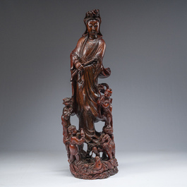 A large Chinese carved wooden figure of Guanyin with children, 20th C.