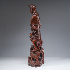 A large Chinese carved wooden figure of Guanyin with children, 20th C.