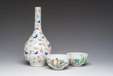 A Chinese famille rose '100 butterflies' vase and two bowls with peaches and balsam pears, Qianlong mark, 20th C.