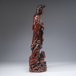 A large Chinese carved wooden figure of Guanyin with children, 20th C.