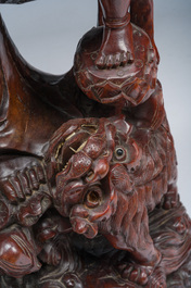 A large Chinese carved wooden figure of Guanyin with children, 20th C.