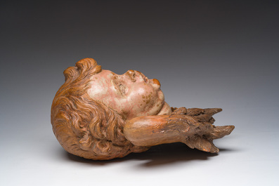 A polychromed terracotta cherub head, probably France, 18th/19th C.