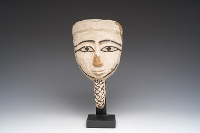 An Egyptian wooden sarcophagus mask with white stucco and black accents, Late Period, 6th-1st C. b.C.
