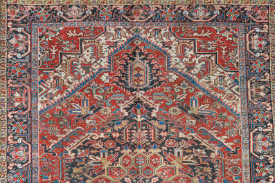 A Persian Heriz rug with floral design, wool on cotton, 20th C.