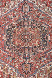 A Persian Heriz rug with floral design, wool on cotton, 20th C.
