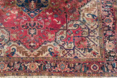 A Persian Heriz rug with floral design, wool on cotton, first half 20th C.