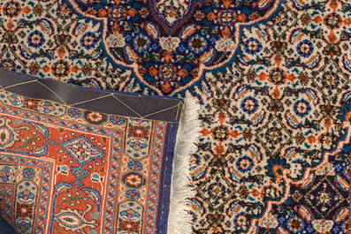 Two Persian Bakhtiar rugs with floral design, wool on cotton, 20th C.