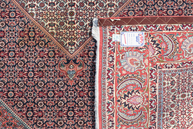 A Persian Bidjar rug with floral design, wool on cotton, 20th C.