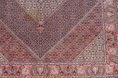 A Persian Bidjar rug with floral design, wool on cotton, 20th C.