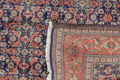 A Persian Tabriz rug with floral design, wool on cotton, 20th C.