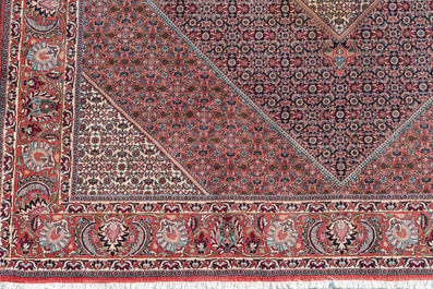 A Persian Bidjar rug with floral design, wool on cotton, 20th C.