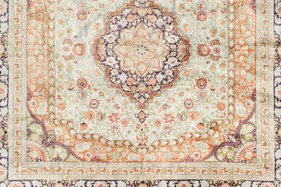 A Chinese silk Hereke style rug with floral design, 20th C.