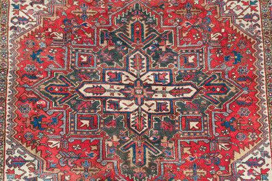A Persian Heriz rug with floral design, wool on cotton, 20th C.