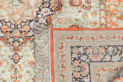 A Chinese silk Hereke style rug with floral design, 20th C.