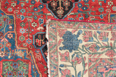 A Persian Bakhtiar rug with floral design, wool on cotton, 20th C.