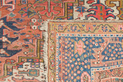 A Persian Heriz rug with floral design, wool on cotton, 20th C.