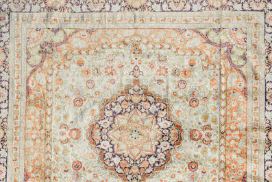 A Chinese silk Hereke style rug with floral design, 20th C.