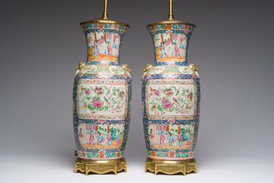 Een paar Chinese Kanton famille rose vazen met blauwe fondkleur, paleissc&egrave;nes en floraal decor omgevormd tot lampen, 19de eeuw