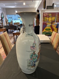 A pair of Chinese famille rose 'animated palace scene' vases, 19th/20th C.