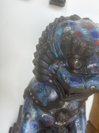 A pair of Chinese cloisonn&eacute; Buddhist lions on a wooden base, 20th C.