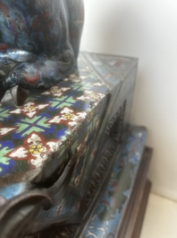 A pair of Chinese cloisonn&eacute; Buddhist lions on a wooden base, 20th C.