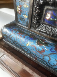 A pair of Chinese cloisonn&eacute; Buddhist lions on a wooden base, 20th C.