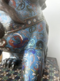 A pair of Chinese cloisonn&eacute; Buddhist lions on a wooden base, 20th C.