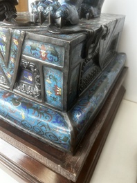 A pair of Chinese cloisonn&eacute; Buddhist lions on a wooden base, 20th C.