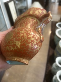A Chinese ewer-shaped coral-red ground wall pocket vase with gilt lotus scrolls, Qianlong mark, 20th C.