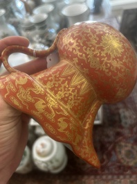 A Chinese ewer-shaped coral-red ground wall pocket vase with gilt lotus scrolls, Qianlong mark, 20th C.