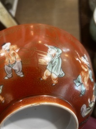 A Chinese coral-red ground famille verte bowl with playing boys, 19th/20th C.
