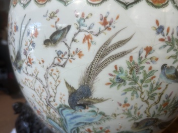 A Chinese famille rose jardini&egrave;re with birds on blossoming branches on an openworked carved wooden stand with marble top, 19th/20th C.