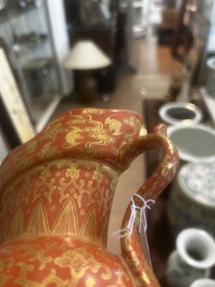 A Chinese ewer-shaped coral-red ground wall pocket vase with gilt lotus scrolls, Qianlong mark, 20th C.